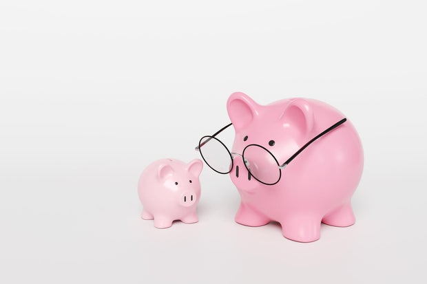 A big pink mother piggy bank wearing spectacles and a smaller one on a white background. Illustration of the concept of investment, fund and planning for children education 