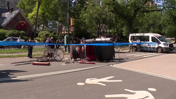 Horse carriage laying on its side in the street