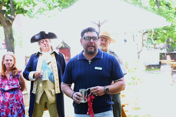 People pose for photos at City Tavern Garden 