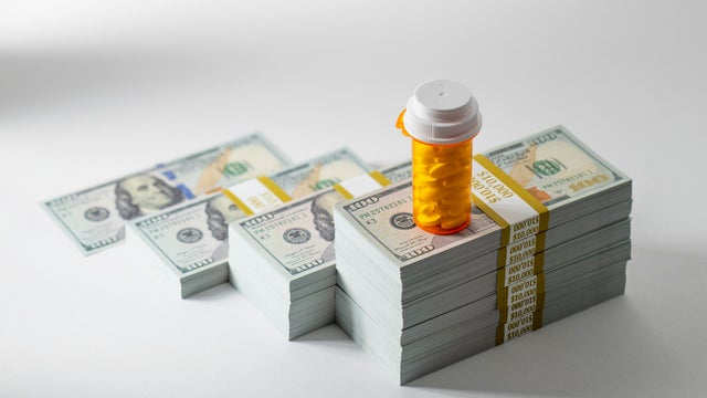 Rising cost of prescription medication - Pill bottle on money 