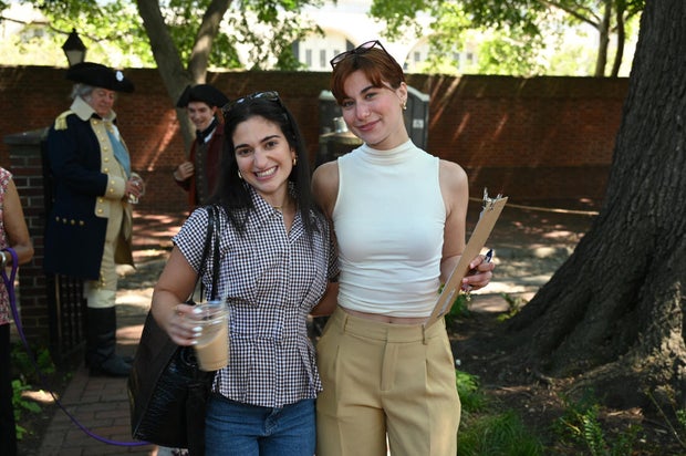 People pose for photos at City Tavern Garden 