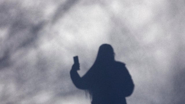 Shadow of person with smart phone 