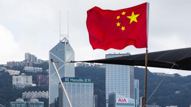 Chinese National Flag Flies with Bank of China Tower in Background 