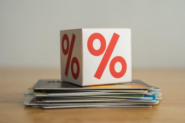 Can creditors charge interest on unpaid debts after someone dies?