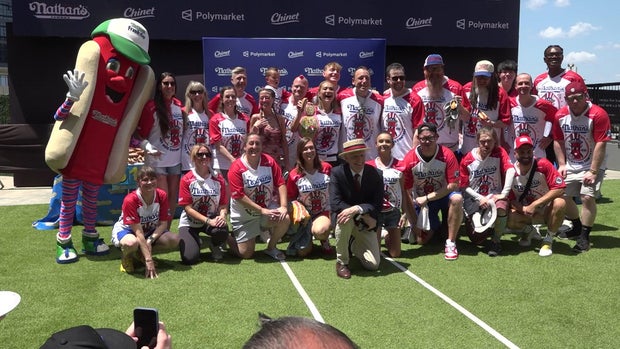 George Shea poses with competitors at the weigh-in for the 110th Annual Nathan's Hot Dog Eating Contest on July 3, 2026.