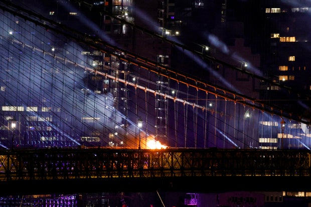 A fire burns on the Brooklyn Bridge after the Macy's Fourth of July Fireworks celebration in New York, on July 4, 2026.