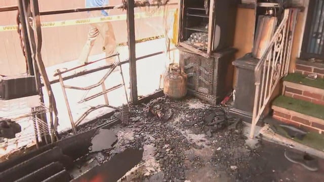 Fire damage and ash are visible inside the porch of the mosque 