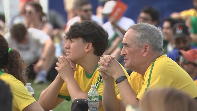 Two people watch a match during FIFA Fan Festival in Philadelphia 