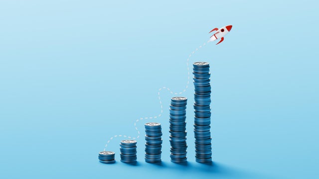 Launch from Growth &ndash; Rocket Lifting Off from Rising Coin Stacks Tracing a Path of Financial Momentum 