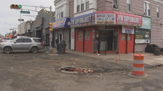 Debris and cones are seen outside JYM grocery store a day after flash flooding in the area 