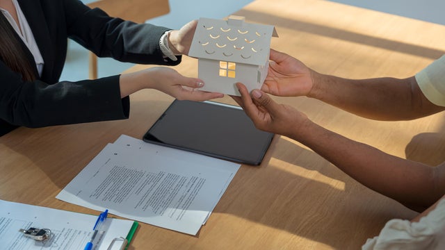 Real estate agent presenting and consult to customer to decision making sign contract agreement, home model, concerning mortgage loan offer for and house insurance. 