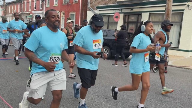 People, many wearing blue t-shirts, run in the event that raises awareness about human trafficking 