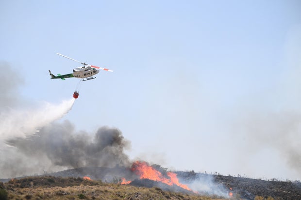 Hundreds of firefighters in Spain battle deadly wildfires that killed at least 12