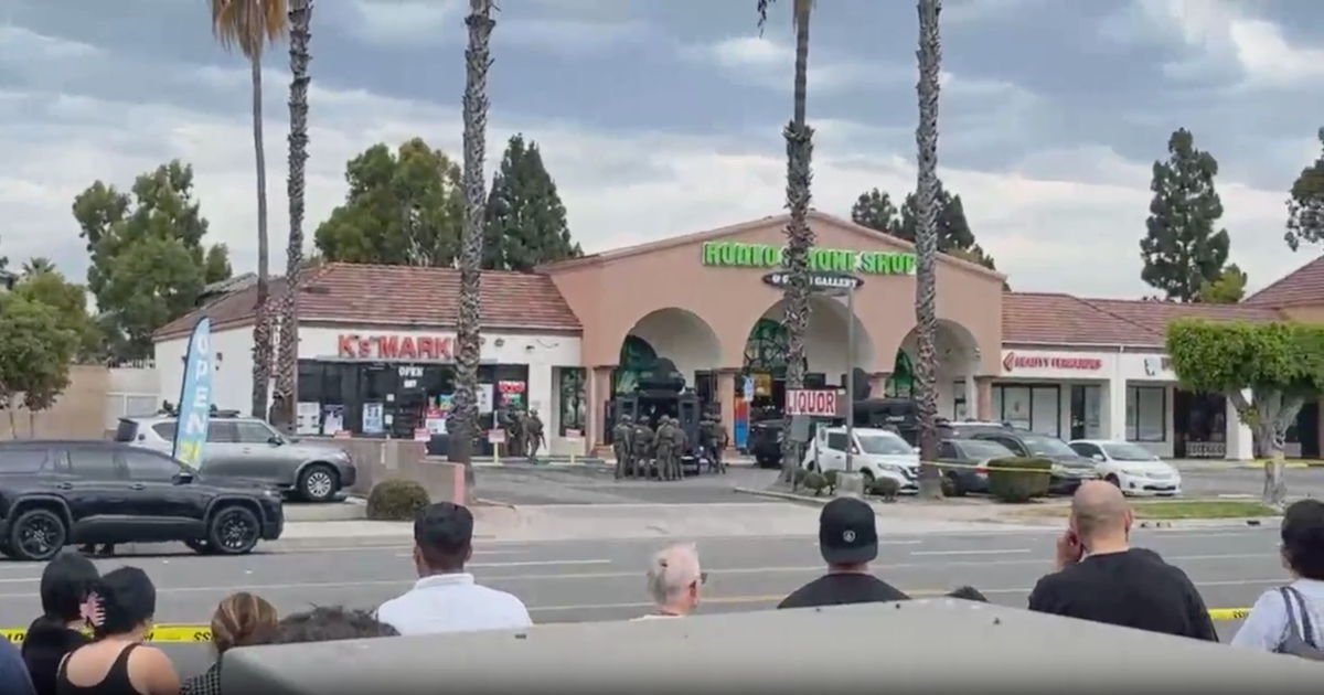 Man armed with knives and axe arrested after barricading inside Orange County business, police say
