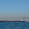 Large oil tanker ship smoking sails Strait of Hormuz, Persian Gulf, Iran 