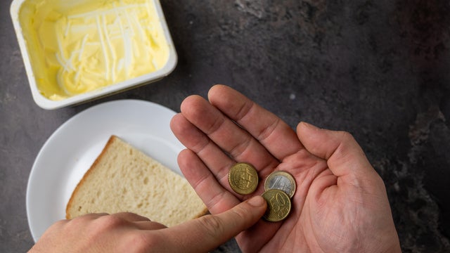 Hands Choosing Food With Limited Money 