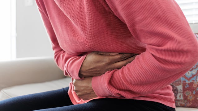 Woman Holds Her Abdomen in Pain 