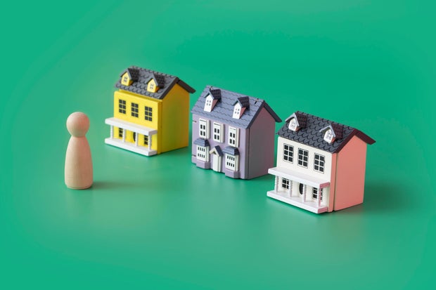 House ownership concepts still life with model house and figurine. 