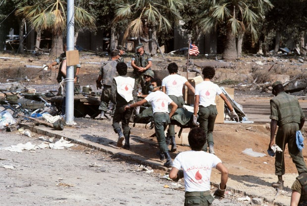 Lebanese volunteer rescue workers carry the body of an