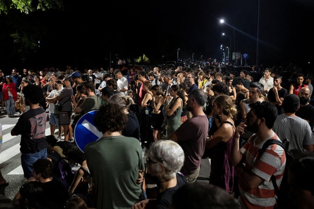 People gather near the scene where Abderrahim Fakir died while being held to the ground by police trying to arrest him in Bologna, Italy, July 19, 2026.
