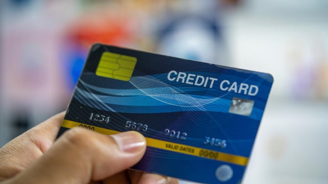 Close up a man hand holding a blue credit card. 