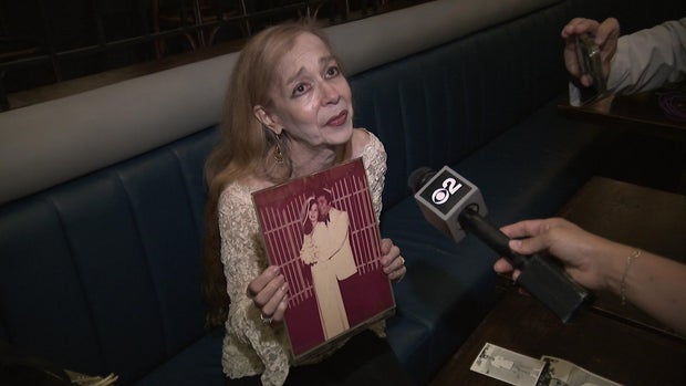Ida Goldstein holds a wedding photo of herself and Robert Goldstein 
