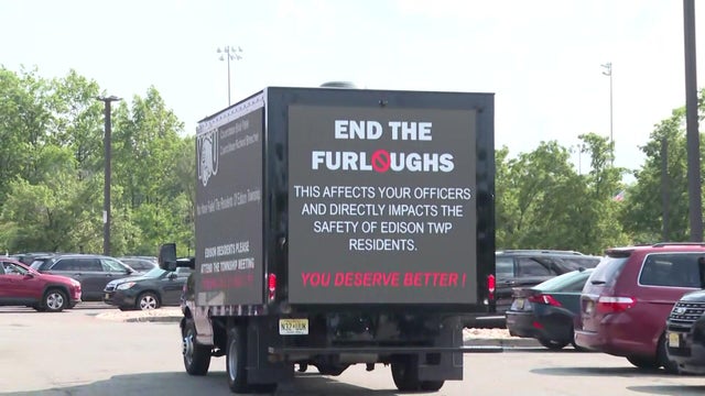 Moving billboard reading in part "end the furloughs" 