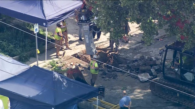 Crews excavate near a house in Philadelphia's Olney section 