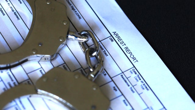 Bail bond concept with handcuffs and police arrest report 