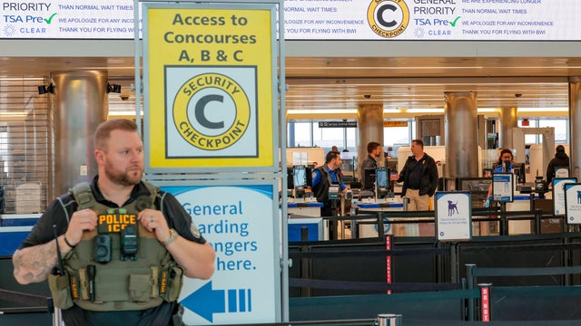Airport security checkpoint with ICE and TSA officers 