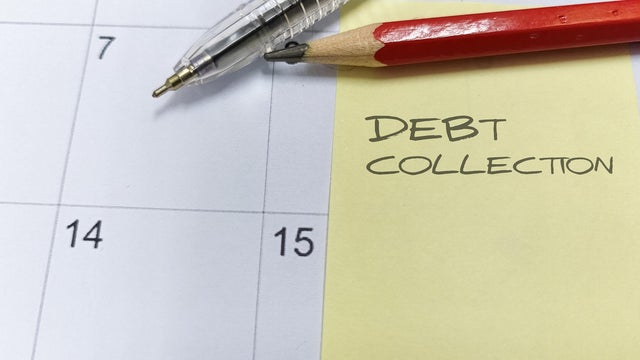 "Debt Collection" written on a sticky note on a calendar, representing deadlines, financial pressure, and credit management. 