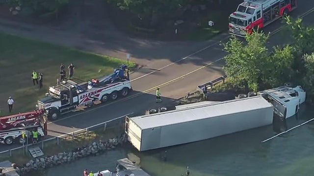 Semi-truck overturns into Michigan lake 
