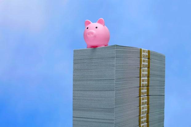 Savings concept - Piggy bank on cash