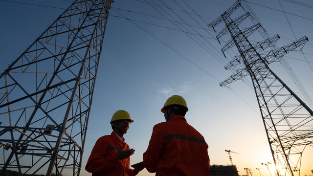 Workers checking high-voltage power lines. 