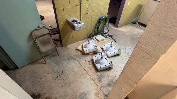 Sinks are ripped out of the wall and lying on the floor of a football practice facility in Philadelphia
