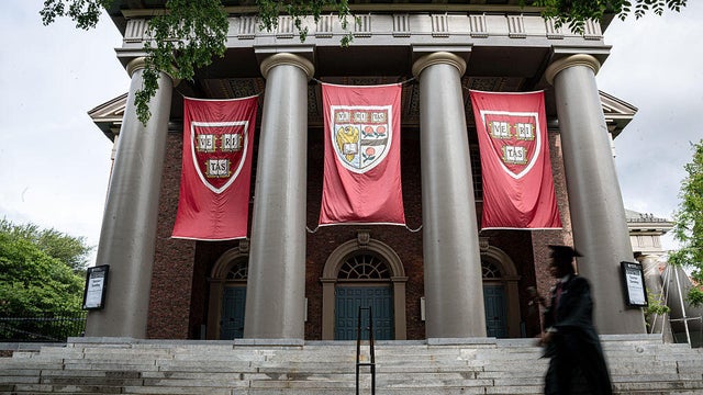 A person runs past Dunster House at Harvard University on March 17, 2025, in Cambridge, Massachusetts. 
