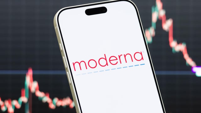 Moderna Logo Shown on Smartphone with Latest Stock Market Chart 