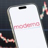 Moderna Logo Shown on Smartphone with Latest Stock Market Chart 