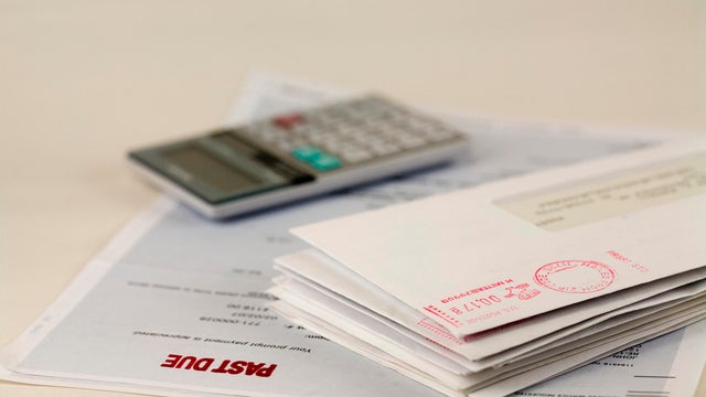 A stack of bills and a calculator 