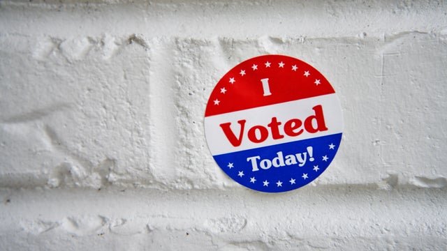 I Voted sticker on a white wall 