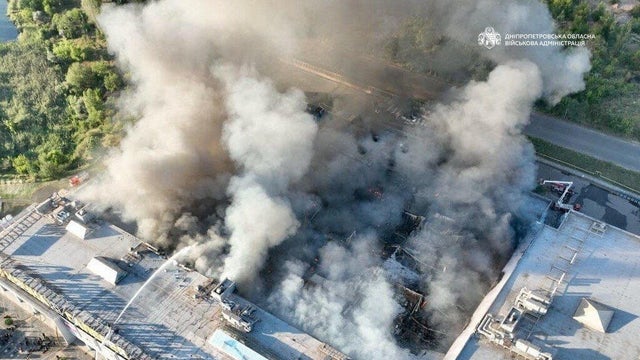 Firefighters work at the site of a shopping mall hit by Russian drone strikes in Kryvyi Rih, Ukraine, Aug. 21, 2026. 