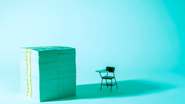 The cost of Education - Money and desk 
