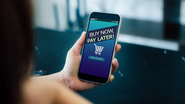 Buy now pay later concept with smartphone and digital payment technology. Online shopping, credit service, and fintech solutions enable flexible transactions, boost sales. 