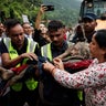 Police officers carry a survivor to a safer place following a flash flood at Trishuli, Nepal 