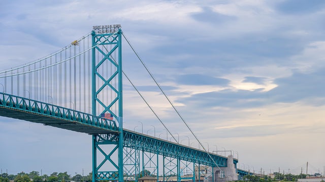 Ambassador suspension bridge spanning calm water beneath 