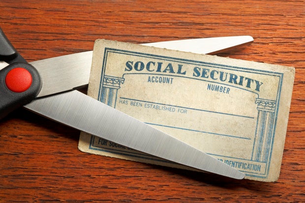 Pair Of Scissors About To Cut A Social Security Card