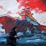 A commuter walks past a mural in Tehran, Iran, Aug. 31, 2026. 