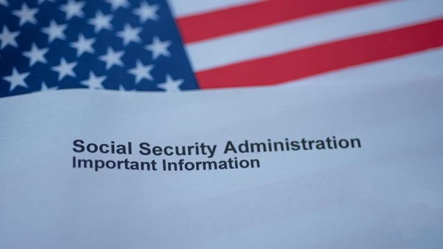 Social Security Administration Important Information letter next to flag of USA. 