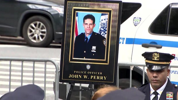 A plaque with a photo of NYPD Officer John William Perry