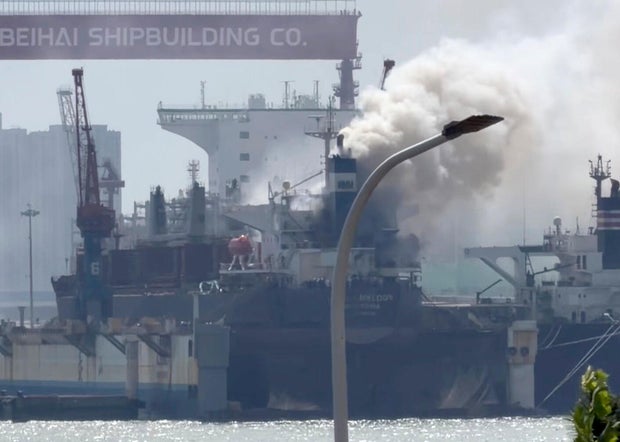 Smoke billows out from a cargo ship that caught fire while docked at a port in the city of Qingdao in eastern China's Shandong province, in a photo from video taken Sept. 10, 2026, and released by Qingdaowolin. 